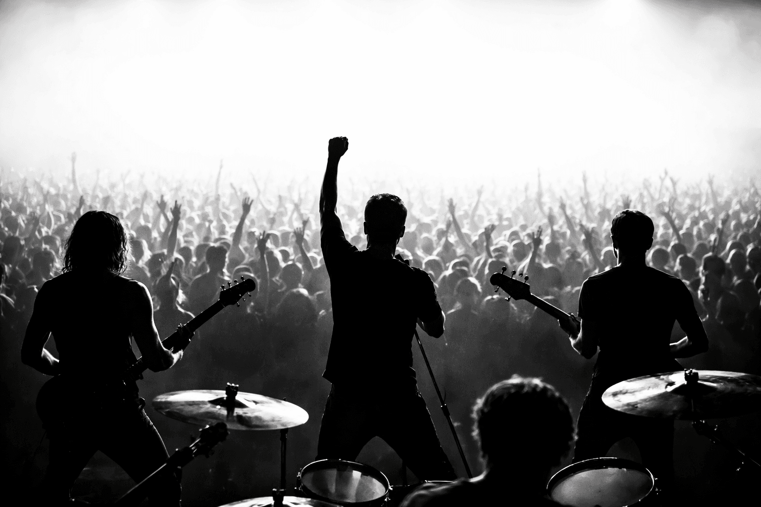 Band performing live on stage in front of a packed crowd
